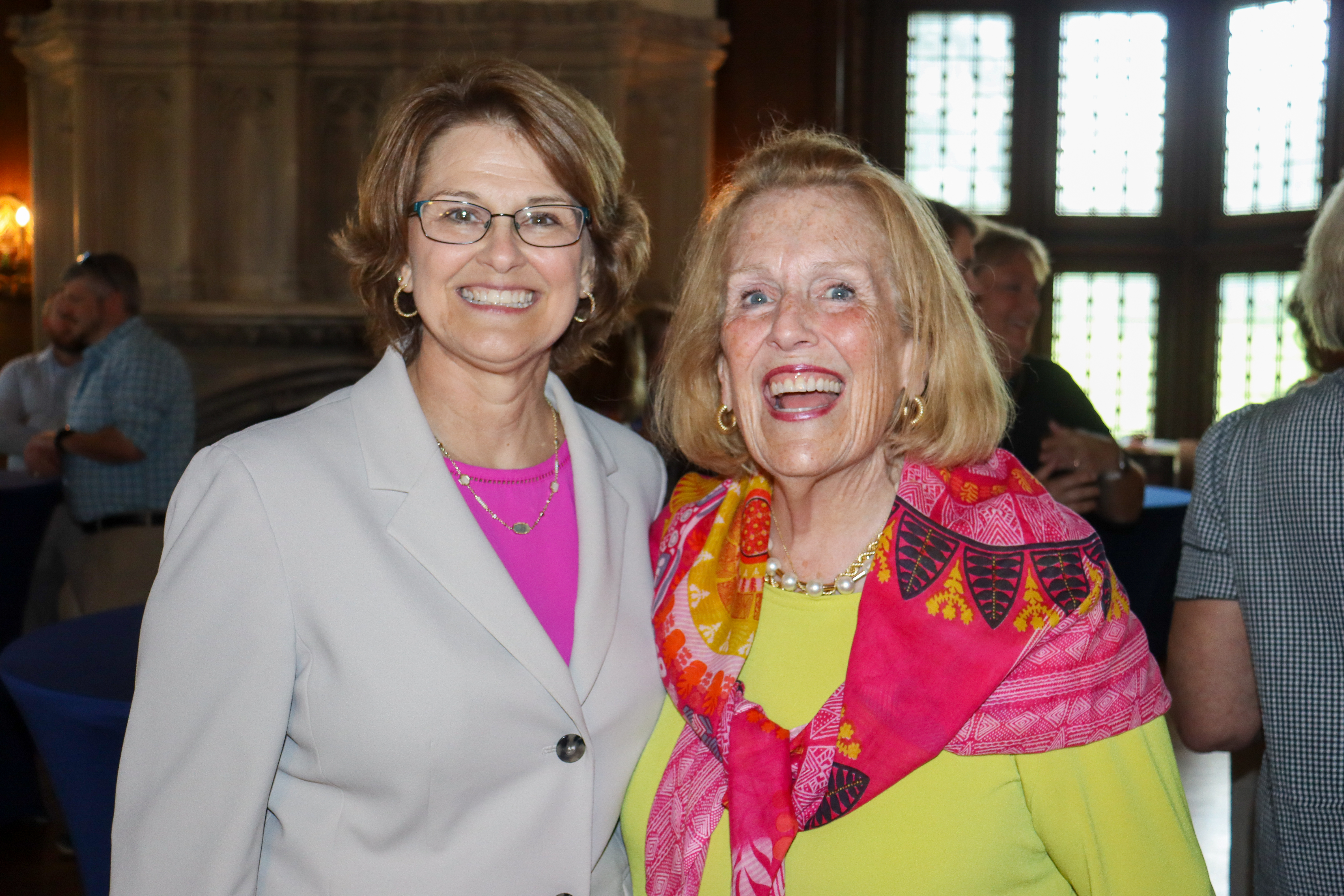 Two women smile at Retirement Reception at Berry Mansion.jpg